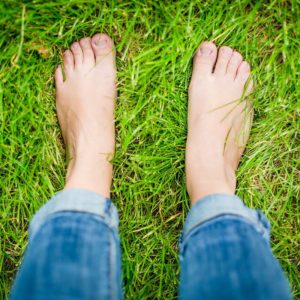 Picture of bare feet standing in grass.