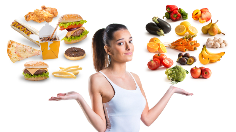 Female with fast food above her left hand, and organic food above her right hand.