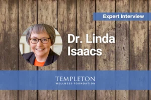 Headshot of Dr. Linda Isaacs for the Templeton Wellness Expert Interview with James Templeton on coffee enemas for cancer, personalized nutrition, and natural healing strategies, over a rustic wood background with Templeton Wellness Foundation branding.