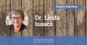 Headshot of Dr. Linda Isaacs with text reading “Expert Interview” and “Dr. Linda Isaacs” over a rustic wood background, Templeton Wellness Foundation branding.